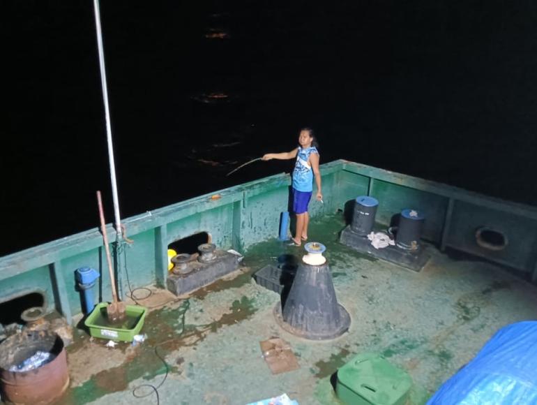 An abandoned seafarer fishing off the side of his ship for food An abandoned seafarer fishing off the side of his ship for food